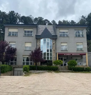 an apartment building with a driveway in front of it at A lastra in Villamartín