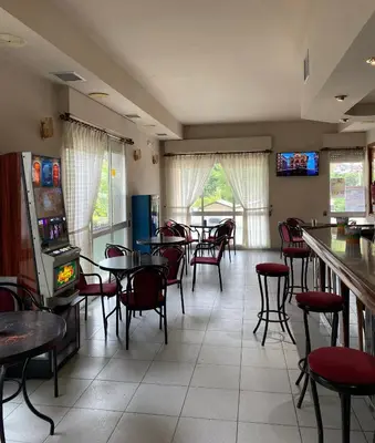 a restaurant with tables and chairs and a bar at A lastra in Villamartín