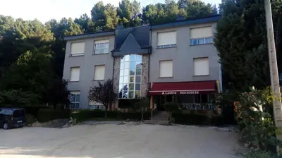a building with a car parked in front of it at A lastra in Villamartín