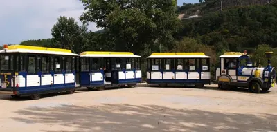 three blue and white trolley cars parked in a parking lot at Hotel Irixo in Ourense
