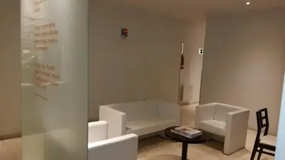 a room with two white chairs and a table at Hotel Irixo in Ourense