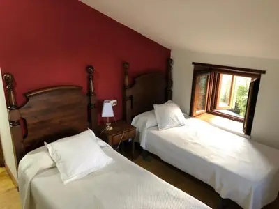 a bedroom with two beds and a window at Casa Navarro in O Cebreiro