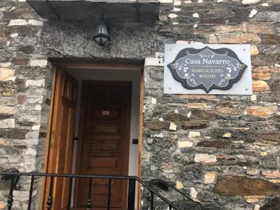 a sign on the side of a building with a door at Casa Navarro in O Cebreiro