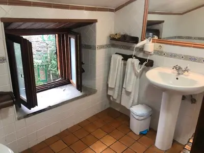 a bathroom with a sink and a window at Casa Navarro in O Cebreiro
