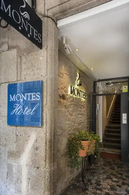 a store with signs on the side of a building at Hotel Montes in Santiago de Compostela