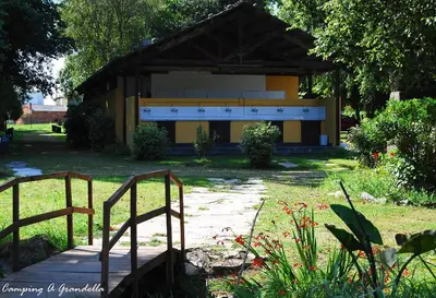 a building with a bench in front of it at CAMPING A GRANDELLA in El Franco