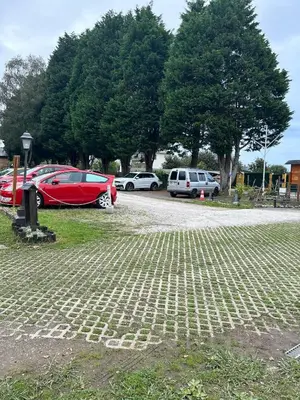 a group of cars parked in a parking lot at CAMPING A GRANDELLA in El Franco