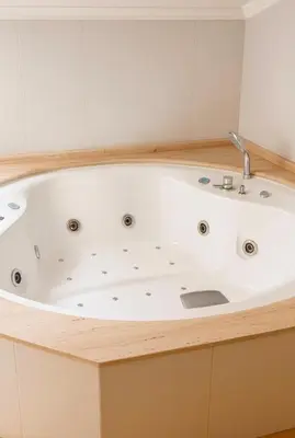 a bath tub in a bathroom with a sink at Hotel Villa de Cacabelos in Cacabelos