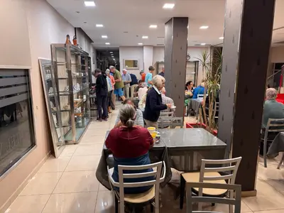 a group of people walking around a store at Hotel Villa de Cacabelos in Cacabelos