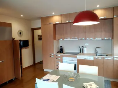 a kitchen with a table and chairs and a red light at Mirador de la Ría in Ribadeo