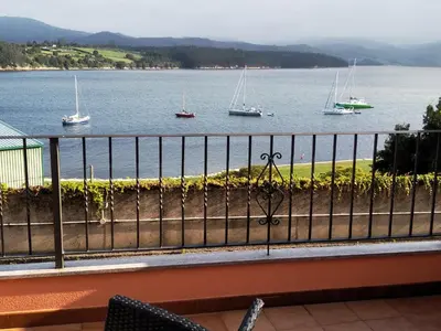 a view of a body of water with boats at Mirador de la Ría in Ribadeo