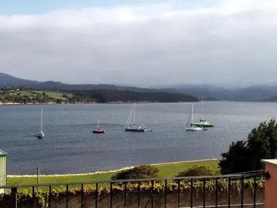 a group of boats in a large body of water at Mirador de la Ría in Ribadeo