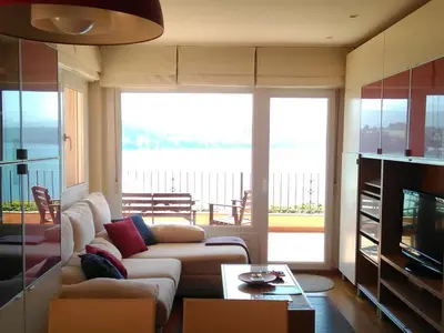 a living room with a couch and a television at Mirador de la Ría in Ribadeo