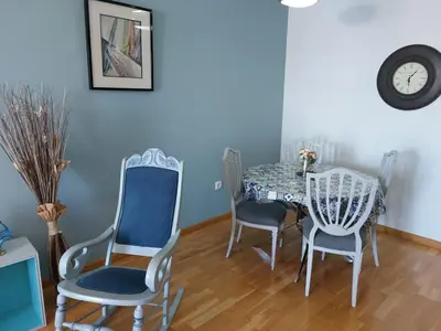 a dining room with a table and chairs and a clock at El Silencio de Galadhrim in Ponferrada