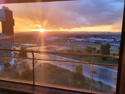 a view from a window of a city at sunset at El Silencio de Galadhrim in Ponferrada