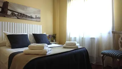 a bedroom with a bed with towels on it at Casa Baixo O Castelo in Puente Caldelas