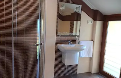 a bathroom with a sink and a mirror at Casa Baixo O Castelo in Puente Caldelas