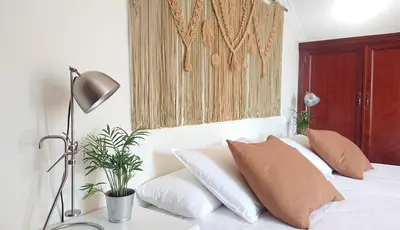 a bedroom with a bed with pillows and a lamp at Casa Baixo O Castelo in Puente Caldelas