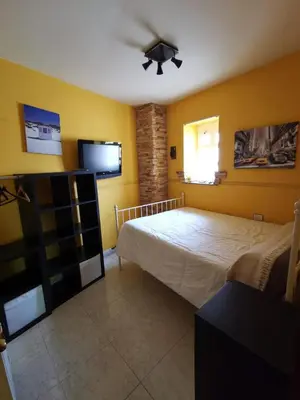 a bedroom with a bed and a ceiling fan at Casa Foz in Foz