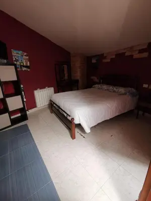 a bedroom with a bed in a red wall at Casa Foz in Foz
