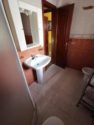 a bathroom with a white sink and a toilet at Casa Foz in Foz
