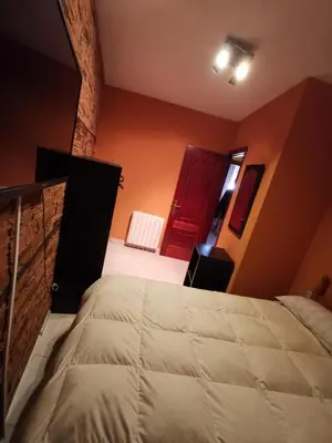 a bedroom with a large bed and a red door at Casa Foz in Foz