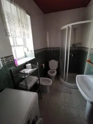 a bathroom with a toilet and a shower and a sink at Casa Foz in Foz