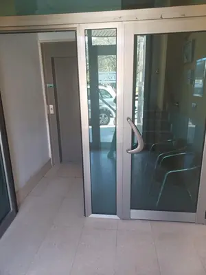 an entrance to a glass door in a building at Hotel 2 de mayo 2 in Xinzo de Limia