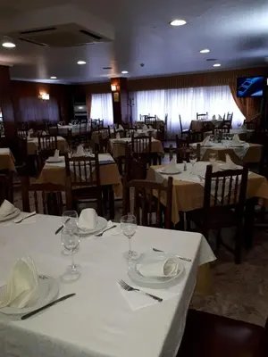 a dining room with tables and chairs with white table cloth at Hotel 2 de mayo 2 in Xinzo de Limia