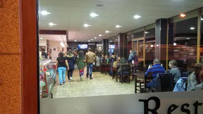 a group of people walking through a restaurant at APARTAMENTOS CASAS NOVAS in Silleda