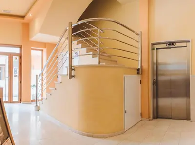 a spiral staircase in a building with a metal door at APARTAMENTOS CASAS NOVAS in Silleda