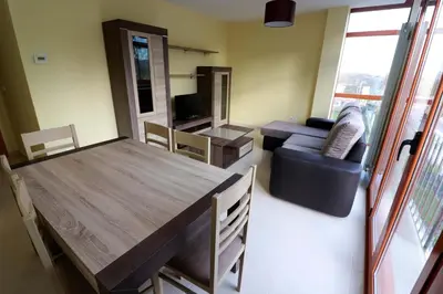 a living room with a wooden table and a couch at APARTAMENTOS CASAS NOVAS in Silleda