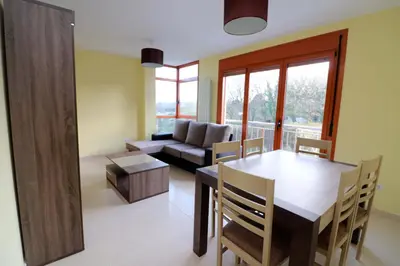 a living room with a table and a couch at APARTAMENTOS CASAS NOVAS in Silleda