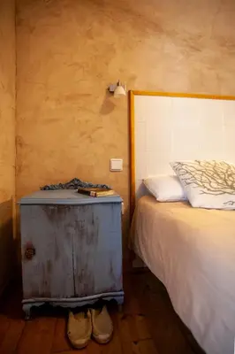 a bedroom with a bed and a wooden floor at CASA COLOMBA in Santa Colomba de Somoza