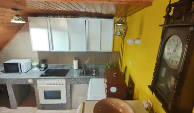 a small kitchen with a sink and a counter top at Casita junto al Río en un entorno natural in Monforte de Lemos