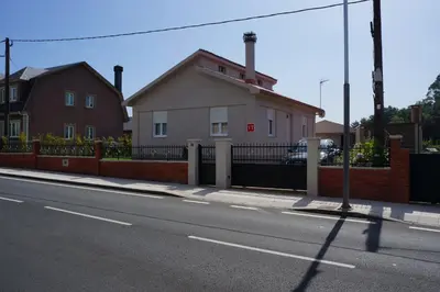 a house on the side of a street at Casa Asientos Boimorto in Boimorto