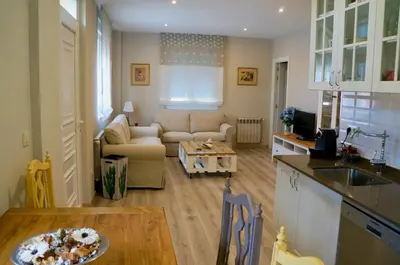 a kitchen and living room with a couch and a table at Casa Asientos Boimorto in Boimorto
