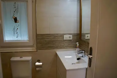 a small bathroom with a sink and a toilet at Casa Asientos Boimorto in Boimorto