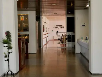 a hallway in a building with a store at Hotel Eumesa in Puentedeume
