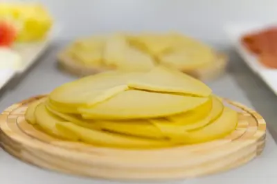 a close up of a stack of yellow cheese at Playa de Foz Hotel & Spa by gaiarooms in Foz