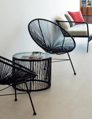two chairs and a table in a room at Playa de Foz Hotel & Spa by gaiarooms in Foz