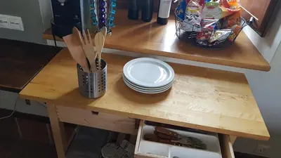 a wooden table with plates and utensils on it at Elteixorural in Teijois