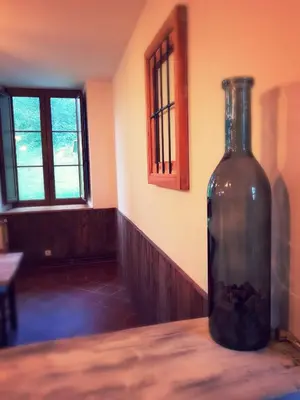 a bottle sitting on a table in a room at Elteixorural in Teijois