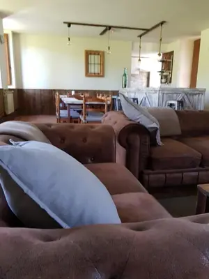 a living room with two brown couches and a table at Elteixorural in Teijois