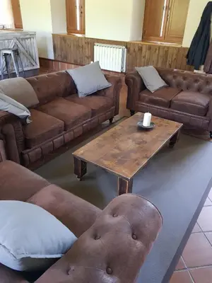 a living room with couches and a coffee table at Elteixorural in Teijois