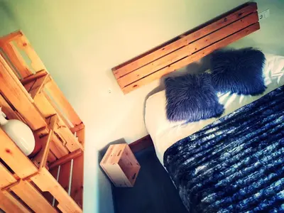 a bedroom with a bed with a wooden head board at Elteixorural in Teijois