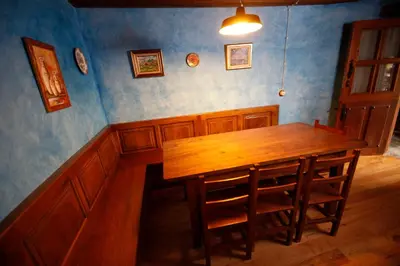 a dining room with a wooden table and chairs at Casa Agudín in Cangas del Narcea