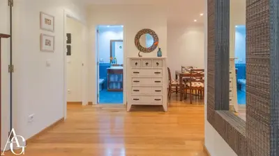 a room with a white dresser and a dining room at Apartamento Plaza de España in Ribadeo