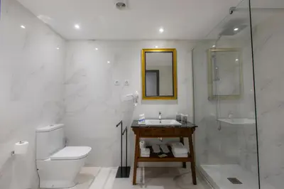a bathroom with a toilet and a sink and a shower at HOTEL JAVIER MONTERO in Ribadeo