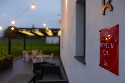 a sign on the side of a building with tables and chairs at HOTEL JAVIER MONTERO in Ribadeo